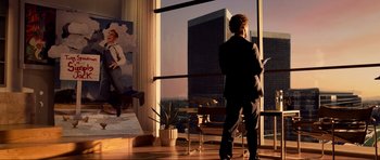 Movie still from “Tropic Thunder” (2008), directed by Ben Stiller – A man standing in front of a window looking out at a city; Wide shot, Low angle
