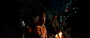 Movie still from “Tropic Thunder” (2008), directed by Ben Stiller – A man is lighting a candle in the dark; Medium shot, High angle