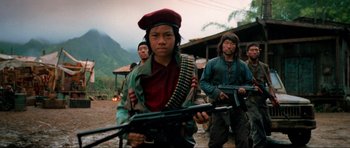 Movie still from “Tropic Thunder” (2008), directed by Ben Stiller – A group of men holding guns in the middle of a field; Medium shot, Low angle
