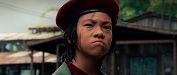 Movie still from “Tropic Thunder” (2008), directed by Ben Stiller – A young man wearing a red hat and a brown jacket; Close Up shot, Low angle