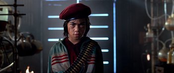 Movie still from “Tropic Thunder” (2008), directed by Ben Stiller – A young man wearing a red hat and holding a rifle; Close Up shot, Low angle