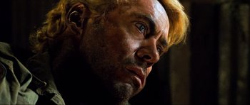 Movie still from “Tropic Thunder” (2008), directed by Ben Stiller – A man with blonde hair looking to his left; Close Up shot, Low angle