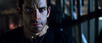 Movie still from “Tropic Thunder” (2008), directed by Ben Stiller – A person wearing a black shirt; Close Up shot, Low angle