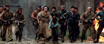 Movie still from “Tropic Thunder” (2008), directed by Ben Stiller – A group of men and a woman walking through the dirt; Medium shot, High angle