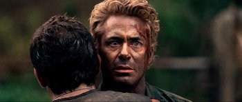 Movie still from “Tropic Thunder” (2008), directed by Ben Stiller – A person with a face covered in blood; Close Up shot, Over the shoulder angle