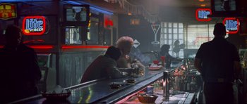 Movie still from “True Romance” (1993), directed by Tony Scott – Two people sitting at a bar in a restaurant; Wide shot, Over the shoulder angle