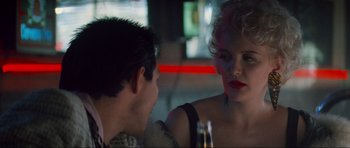 Movie still from “True Romance” (1993), directed by Tony Scott – A man and a woman sitting at a table in front of each other; Close Up shot, Over the shoulder angle