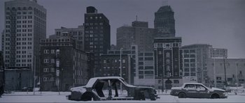 Movie still from “True Romance” (1993), directed by Tony Scott – A car parked on the side of the road covered in snow; Extreme Wide shot, High angle