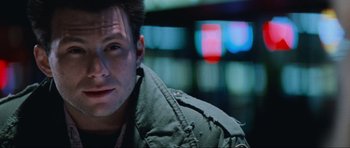 Movie still from “True Romance” (1993), directed by Tony Scott – A person wearing a green jacket; Close Up shot, Low angle