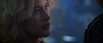 Movie still from “True Romance” (1993), directed by Tony Scott – A woman's face in a dark room; Close Up shot, Over the shoulder angle