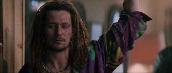 Movie still from “True Romance” (1993), directed by Tony Scott – A man with dreadlocks wearing a colorful shirt; Close Up shot, Low angle