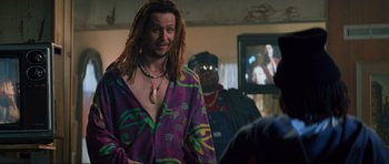 Movie still from “True Romance” (1993), directed by Tony Scott – A man with dreadlocks in a purple shirt; Medium shot, Over the shoulder angle