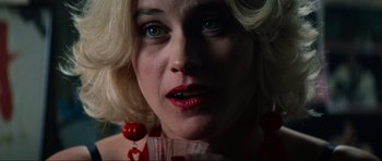Movie still from “True Romance” (1993), directed by Tony Scott – A person with blonde hair and blue eyes; Close Up shot, High angle