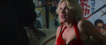 Movie still from “True Romance” (1993), directed by Tony Scott – A woman in a red dress is talking to a man; Close Up shot, Over the shoulder angle