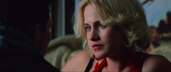 Movie still from “True Romance” (1993), directed by Tony Scott – A woman with blonde hair and blue eyes looking at the camera; Close Up shot, Over the shoulder angle
