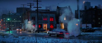 Movie still from “True Romance” (1993), directed by Tony Scott – A car parked on the side of the road in front of a building; Extreme Wide shot, Low angle