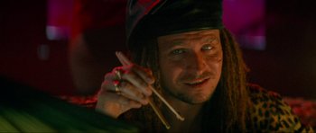 Movie still from “True Romance” (1993), directed by Tony Scott – A person holding a pair of chopsticks; Close Up shot, High angle