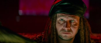 Movie still from “True Romance” (1993), directed by Tony Scott – A person wearing a hat with long dreadlocks; Close Up shot, Low angle