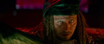Movie still from “True Romance” (1993), directed by Tony Scott – A person wearing a hat with long dreadlocks; Close Up shot, Overhead angle