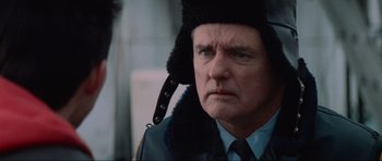 Movie still from “True Romance” (1993), directed by Tony Scott – A person wearing a uniform and a hat; Close Up shot, Over the shoulder angle