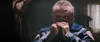 Movie still from “True Romance” (1993), directed by Tony Scott – A man with a bandage on his face; Close Up shot, Low angle
