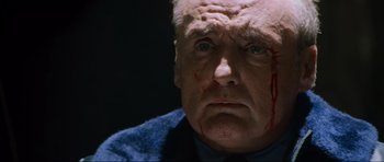 Movie still from “True Romance” (1993), directed by Tony Scott – An older man with a blood covered face; Close Up shot, Low angle