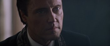 Movie still from “True Romance” (1993), directed by Tony Scott – A man's face in a dark room; Close Up shot, Low angle