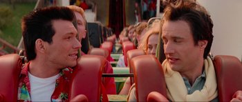 Movie still from “True Romance” (1993), directed by Tony Scott – A group of people sitting in a row of seats on a bus; Close Up shot, Over the shoulder angle