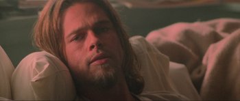 Movie still from “True Romance” (1993), directed by Tony Scott – A person laying on a bed near a window; Close Up shot, Low angle