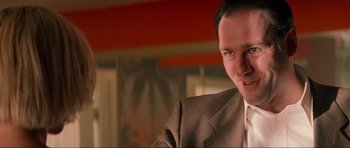 Movie still from “True Romance” (1993), directed by Tony Scott – A person wearing a suit and tie; Close Up shot, Low angle