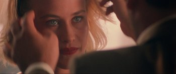 Movie still from “True Romance” (1993), directed by Tony Scott – A person looking into a mirror; Extreme Close Up shot, Over the shoulder angle