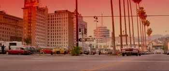 Movie still from “True Romance” (1993), directed by Tony Scott – A view of a street sign and some cars on the road; Extreme Wide shot, Low angle