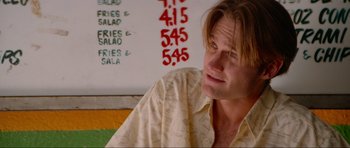 Movie still from “True Romance” (1993), directed by Tony Scott – A person sitting in front of a menu; Close Up shot, Over the shoulder angle