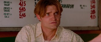 Movie still from “True Romance” (1993), directed by Tony Scott – A person wearing a white shirt; Close Up shot, Low angle