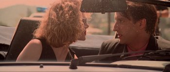 Movie still from “True Romance” (1993), directed by Tony Scott – A man and a woman sitting in the back seat of a car; Close Up shot, Low angle