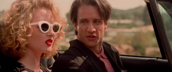 Movie still from “True Romance” (1993), directed by Tony Scott – A man and a woman are sitting next to each other; Close Up shot, Low angle