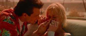 Movie still from “True Romance” (1993), directed by Tony Scott – A man and a woman with blood on their face; Close Up shot, High angle