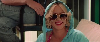 Movie still from “True Romance” (1993), directed by Tony Scott – A woman wearing sunglasses and a blue robe; Close Up shot, Over the shoulder angle