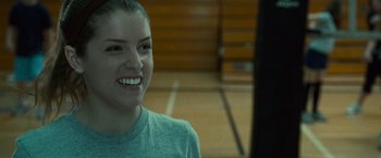 Movie still from “Twilight” (2008), directed by Catherine Hardwicke – A woman smiles while standing in a gym; Close Up shot, Over the shoulder angle