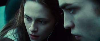 Movie still from “Twilight” (2008), directed by Catherine Hardwicke – A woman and a young man with ear buds; Close Up shot, Over the shoulder angle