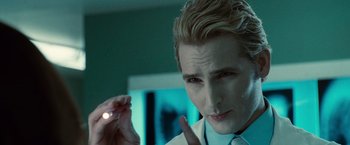 Movie still from “Twilight” (2008), directed by Catherine Hardwicke – A man in a white dress shirt holding a white object; Close Up shot, Over the shoulder angle