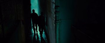 Movie still from “Twilight” (2008), directed by Catherine Hardwicke – Two people walking down a dark hallway in a building; Wide shot, High angle