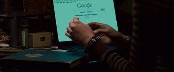 Movie still from “Twilight” (2008), directed by Catherine Hardwicke – A person is holding their hands over a computer screen; Extreme Close Up shot, High angle