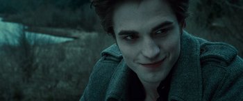 Movie still from “Twilight” (2008), directed by Catherine Hardwicke – A person smiling for the camera; Close Up shot, Over the shoulder angle