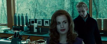 Movie still from “Twilight” (2008), directed by Catherine Hardwicke – A woman sitting in a chair in front of a window; Close Up shot, Over the shoulder angle