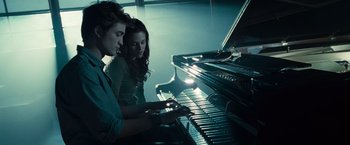 Movie still from “Twilight” (2008), directed by Catherine Hardwicke – A man and a woman are playing a piano; Medium shot, High angle