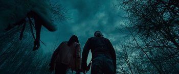 Movie still from “Twilight” (2008), directed by Catherine Hardwicke – A man and a woman holding hands under a cloudy blue sky; Wide shot, Low angle