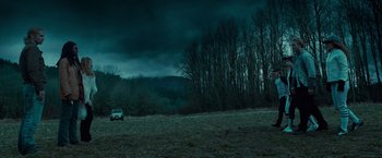 Movie still from “Twilight” (2008), directed by Catherine Hardwicke – A car is parked in a field under a cloudy sky; Extreme Wide shot, Low angle