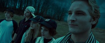 Movie still from “Twilight” (2008), directed by Catherine Hardwicke – A man and two women wearing baseball caps; Close Up shot, Over the shoulder angle