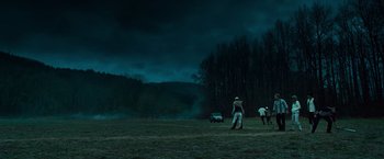 Movie still from “Twilight” (2008), directed by Catherine Hardwicke – A group of people standing on top of a grass covered field; Extreme Wide shot, Low angle